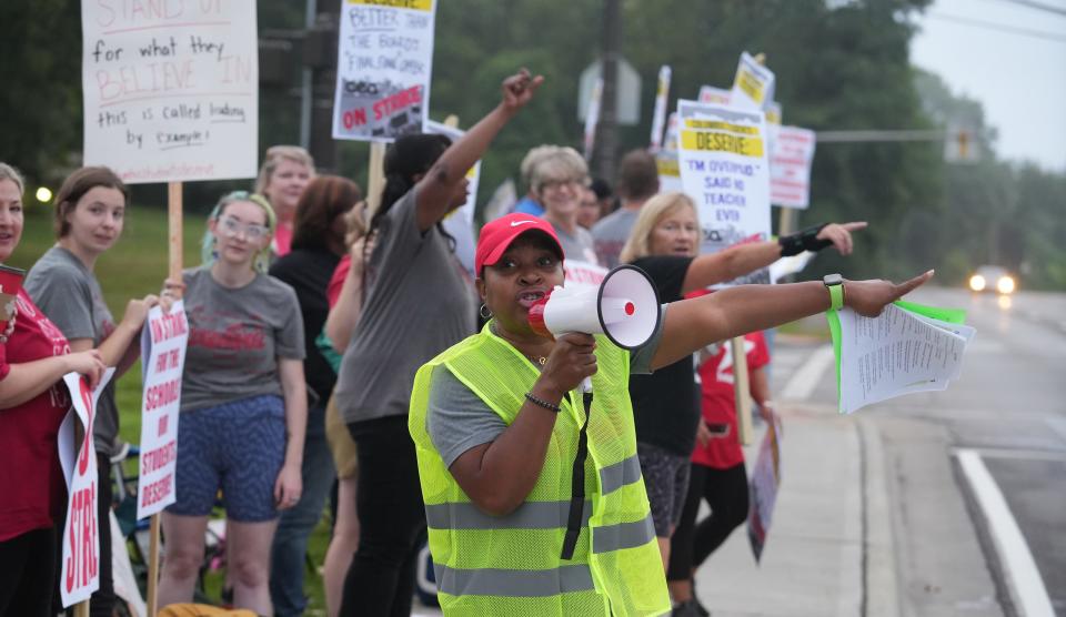 Columbus teachers, including Jeni Hensley of Woodcrest Elementary, picket outside Yorktown Middle School, one of 20 locations where Columbus Education Association members began picketing at 7 a.m. Monday.