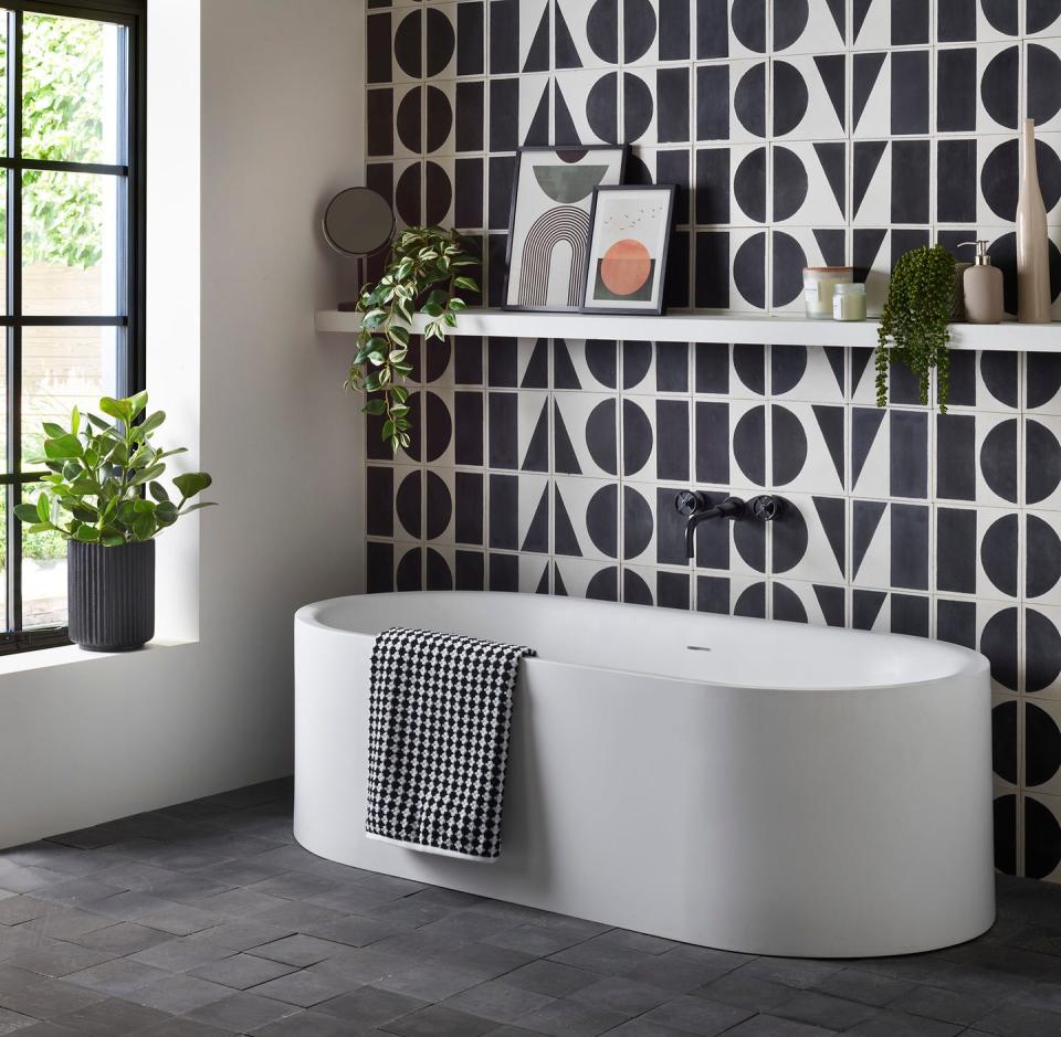 modern geometric tiles in a bathroom with freestanding bathtub