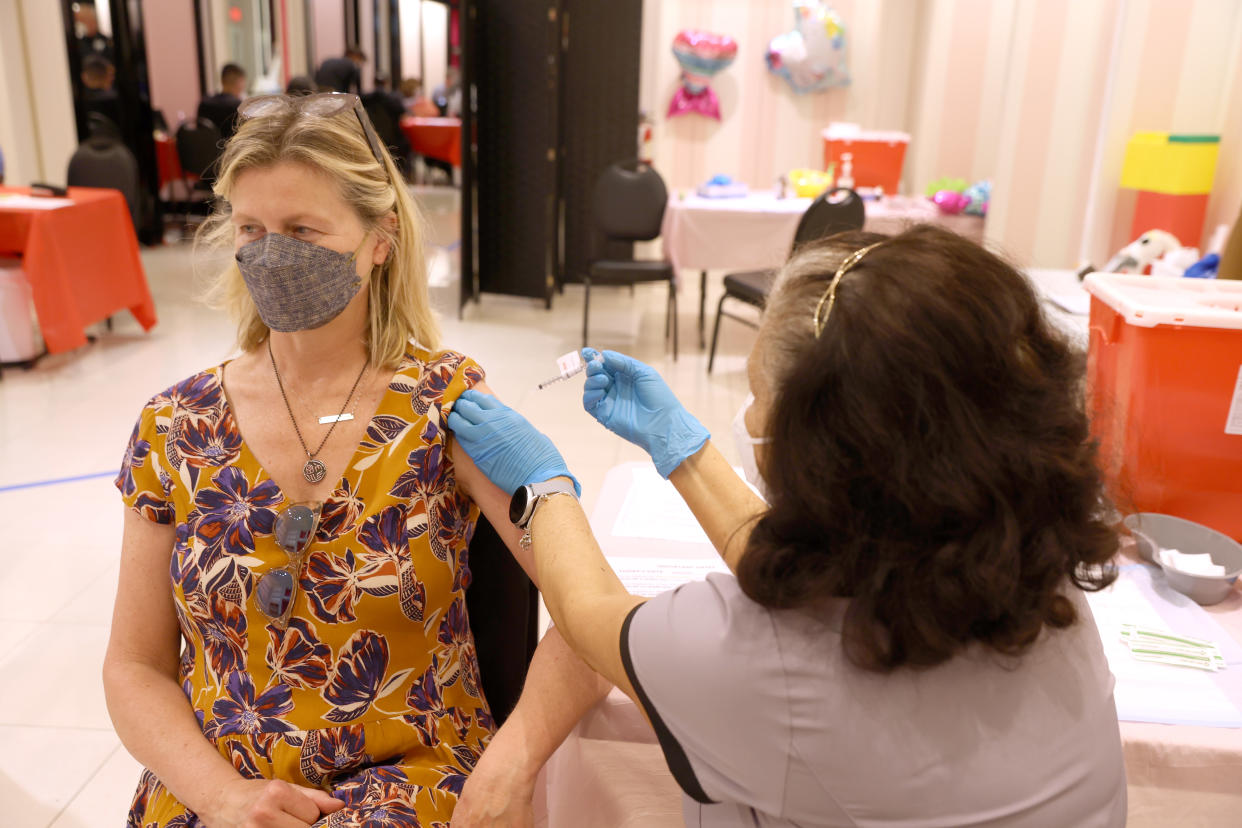 SAN RAFAEL, CALIFORNIA - APRIL 06: Registered Nurse Orlyn Grace (R) administers a COVID-19 booster vaccination to Diane Cowdrey (L) at a COVID-19 vaccination clinic on April 06, 2022 in San Rafael, California. The U.S. Food and Drug Administration has authorized a second COVID-19 booster of Pfizer-BioNTech and Moderna vaccines for people over 50 years old four months after their first booster. (Photo by Justin Sullivan/Getty Images)