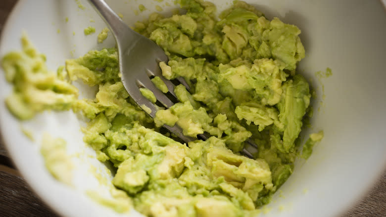 Bowl of mashed avocado