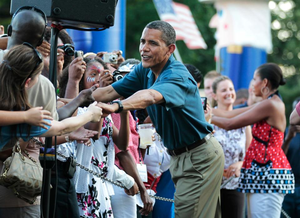 President Barack Obama and first lady Michelle Obama greet members of the U.S. military and their families as they host an Independence Day celebration on the White House's South Lawn on July 4, 2010.