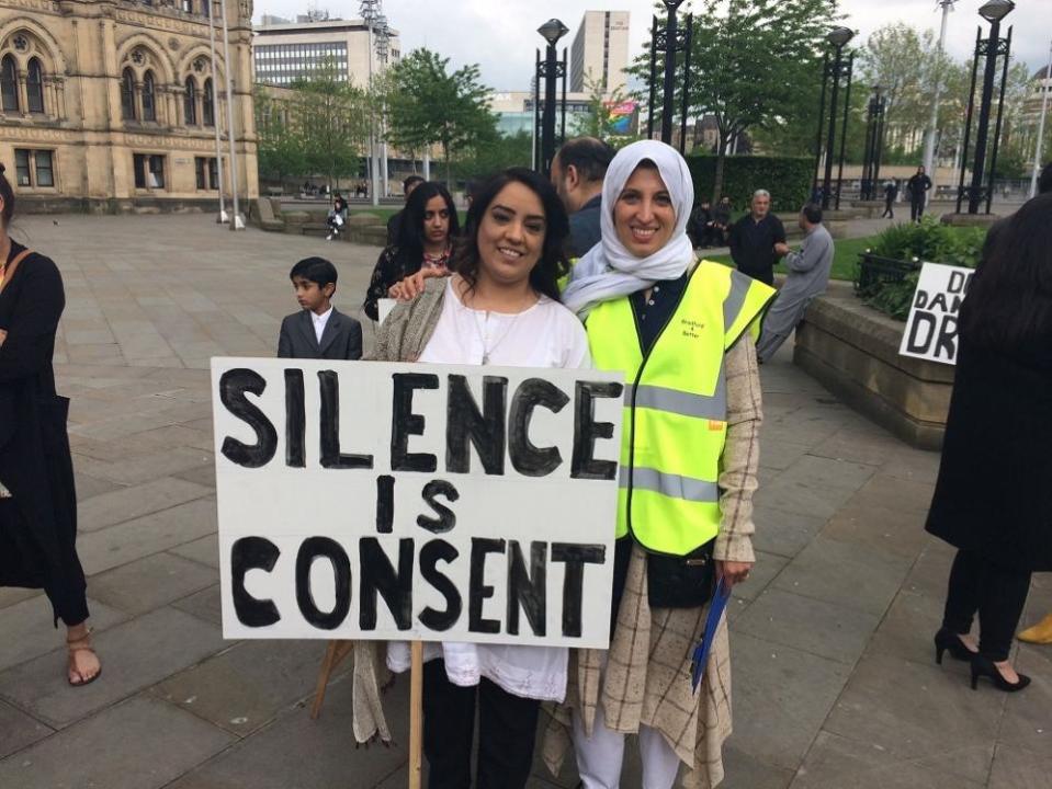 Bradford Telegraph and Argus: Naz Shah and Inayah Sher with one of Bradford4Better's danger driving campaign signs in Centenary Square