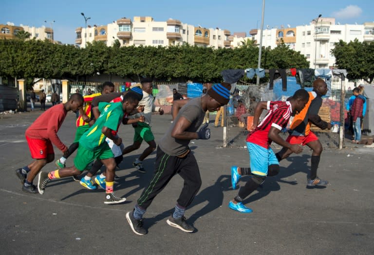 Sub-Saharan migrants train on a makeshift football pitch at the Oulad Ziane migrant camp in Casablanca on February 19, 2018