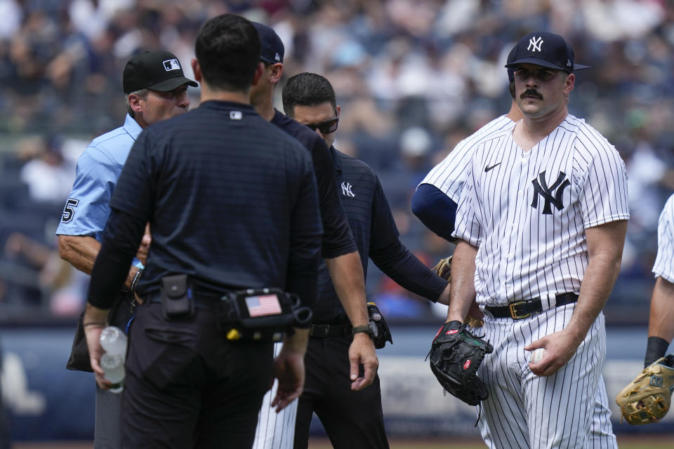 New York Yankees' Carlos Rodon, right, reacts as he is pulled during the third inning of a baseball game against the Houston Astros at Yankee Stadium, Sunday, Aug. 6, 2023, in New York. (AP Photo/Seth Wenig)