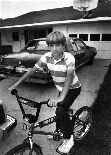 This Aug. 1, 1985 file picture shows Ryan White, 13, with his bicycle in front of his home in Kokomo, Ind. School officials barred the 13-year-old from attending middle school after learning he had contracted AIDS during treatment of hemophilia.