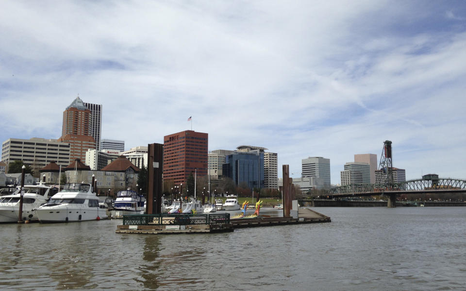 FILE - This March 18, 2016, file photo shows the Willamette River and skyline in the background in Portland, Ore. Portland is again expected to be a flashpoint because of a right-wing rally planned Saturday, Aug. 17, 2019, in the liberal city. The out-of-town groups will likely be met by anti-fascist protesters and the police will be out in force. The city has seen violent protests before. (AP Photo/Terrence Petty, File)