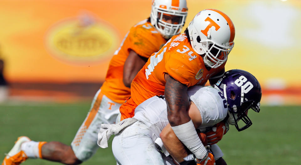 TAMPA, FL – JANUARY 1: Austin Carr #80 of the Northwestern Wildcats is tackled by Darrin Kirkland Jr. #34 of the Tennessee Volunteers during the Outback Bowl at Raymond James Stadium on January 1, 2016 in Tampa, Florida. (Photo by Mike Carlson/Getty Images)