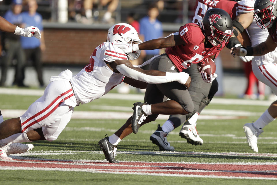 Wisconsin linebacker Maema Njongmeta, left, tackles Washington State running back Jaylen Jenkins (6) during the first half of an NCAA college football game, Saturday, Sept. 9, 2023, in Pullman, Wash. (AP Photo/Young Kwak)