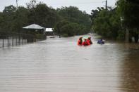 Rescue workers are seen on a flooded street, after Storm Laura passed through Santo Domingo