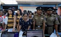 Twins wait in the line to register their names during an event to attempt to break the world record for the biggest gathering of twins in Colombo