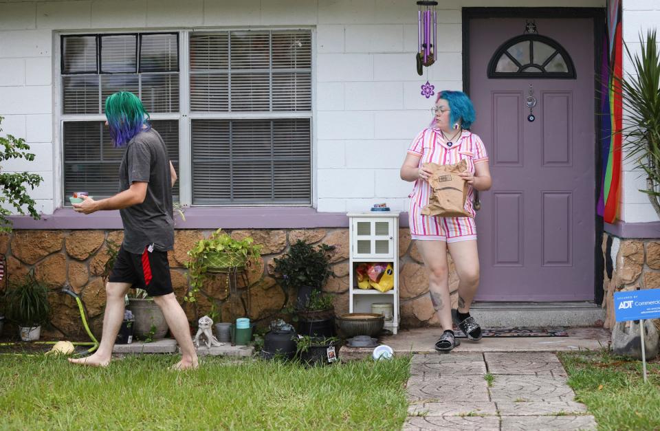 Tyler Simmons (left), 30, and his fiance Judas Rose, 24, hangout in their yard, Friday, Aug. 18, 2023, in Fort Pierce. They bought the fixer-upper home in April. Even though homeownership rates for younger homebuyers (under 44 years) in the U.S. increased from 2019 to 2022, according to the Census Bureau’s Current Population Survey/Housing Vacancy Survey, they are now being priced out of the market due to the increasing interest rates on mortgages.