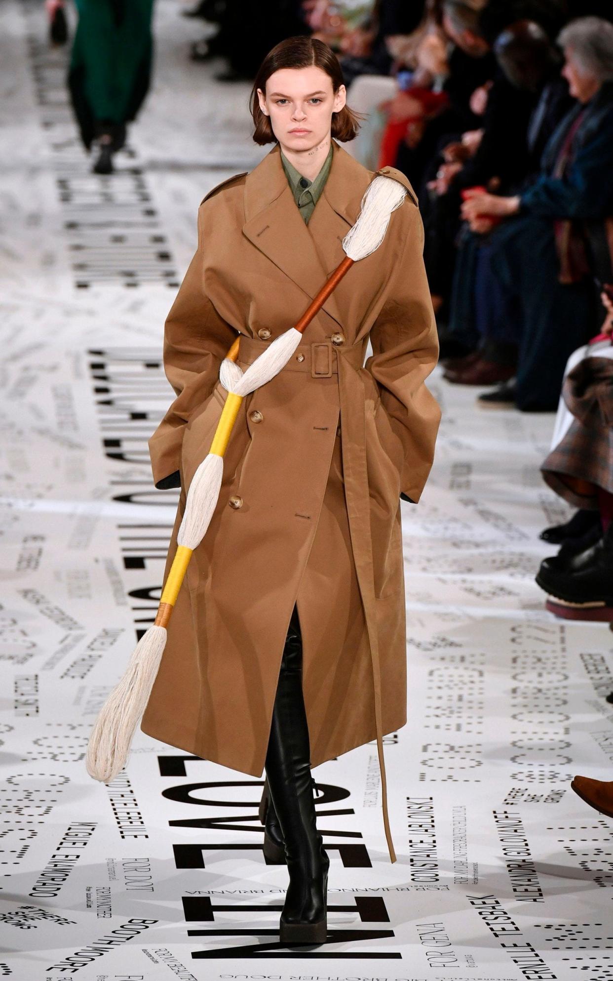 A model wears twisted upcycled yarns over a classic trench coat at Stella McCartney. - AFP