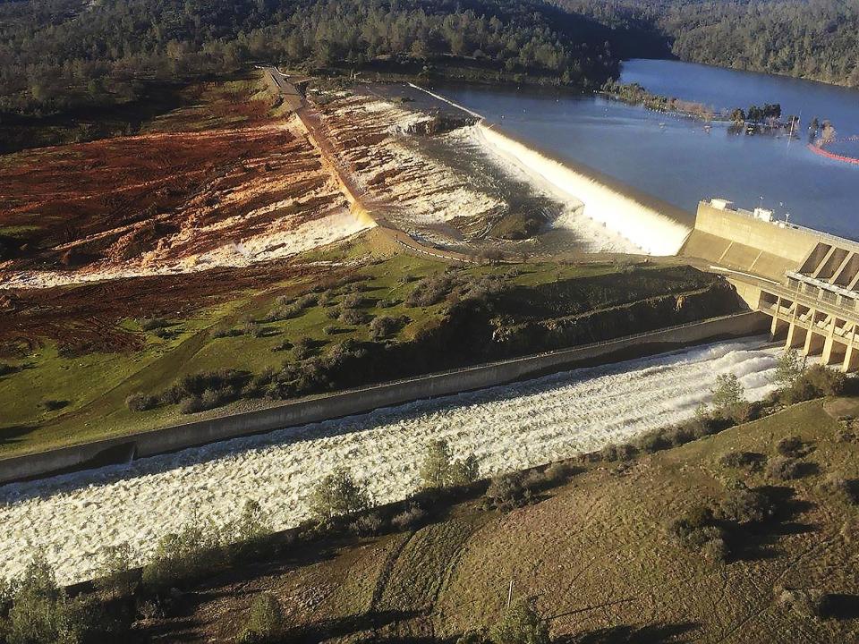 The main spillway, bottom, and an auxiliary spillway, upper, of the Oroville Dam at Lake Oroville in Oroville, Calif. Water will continue to flow over the emergency spillway at the nation's tallest dam for another day or so (Albert Madrid/California Department of Water Resources via AP)