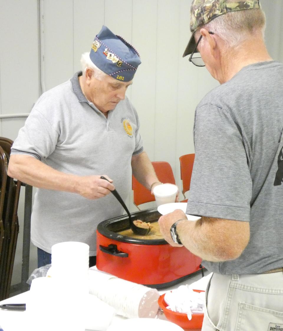 Terry Clegg of American Legion Post 181, left, serves bean soup to veterans during the 2022 Crawford County Fair.