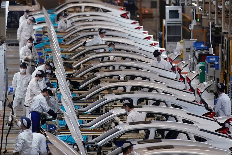FILE PHOTO: Employees work on a production line inside a Dongfeng Honda factory in Wuhan