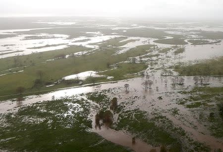 Flooded areas can be seen from an Australian Army helicopter after Cyclone Debbie passed through the area near the town of Bowen, located south of the northern Queensland town of Townsville in Australia, March 30, 2017. REUTERS/Gary Ramage/Pool