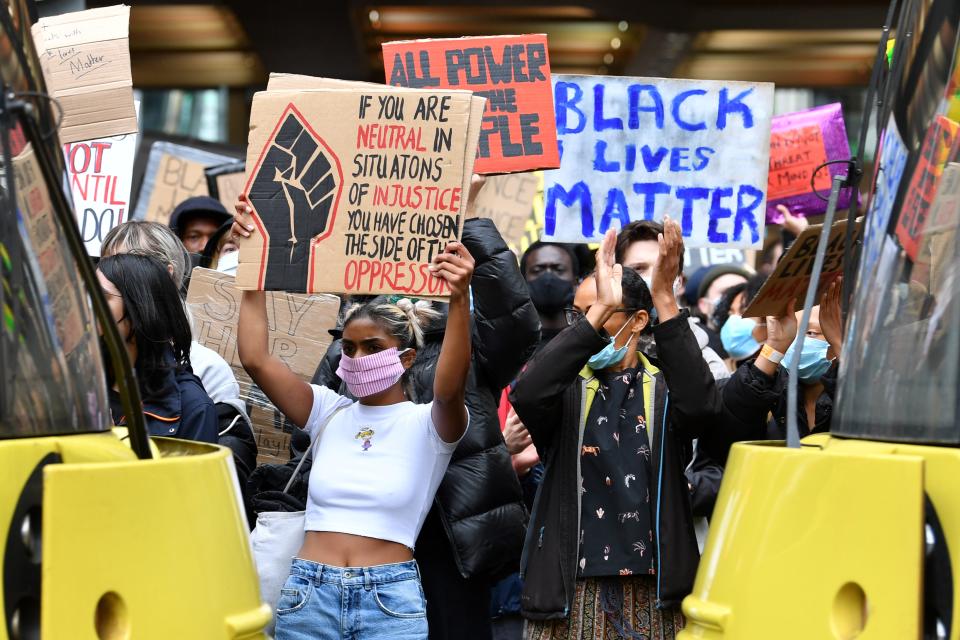 Demonstrators, some wearing PPE (personal protective equipment), including a face mask as a precautionary measure against COVID-19, hold placards as they attend a protest march in Manchester, northern England, on June 6, 2020, to show solidarity with the Black Lives Matter movement in the wake of the killing of George Floyd, an unarmed black man who died after a police officer knelt on his neck in Minneapolis. - The United States braced Friday for massive weekend protests against racism and police brutality, as outrage soared over the latest law enforcement abuses against demonstrators that were caught on camera. With protests over last week's police killing of George Floyd, an unarmed black man, surging into a second weekend, President Donald Trump sparked fresh controversy by saying it was a "great day" for Floyd. (Photo by Paul ELLIS / AFP) (Photo by PAUL ELLIS/AFP via Getty Images)