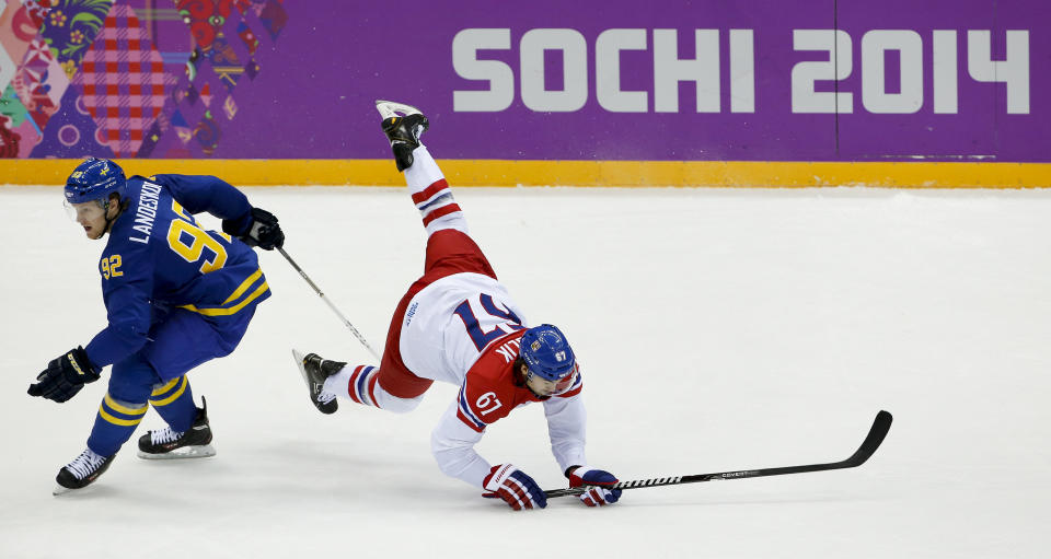 Czech Republic forward Michael Frolik, right, trips against Sweden forward Gabriel Landeskog in the third period of a men's ice hockey game at the 2014 Winter Olympics, Wednesday, Feb. 12, 2014, in Sochi, Russia. Sweden won 4-2.(AP Photo/Julio Cortez)