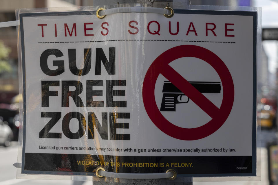 A sign reading Gun Free Zone is seen around Times Square, Wednesday, Aug. 31, 2022, in New York. (AP Photo/Yuki Iwamura)