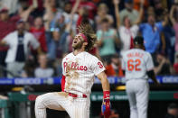 Philadelphia Phillies' Bryce Harper celebrates after scoring the game-winning run on a two-run triple by J.T. Realmuto during the 10th inning of an interleague baseball game against the Baltimore Orioles, Tuesday, Sept. 21, 2021, in Philadelphia. (AP Photo/Matt Slocum)