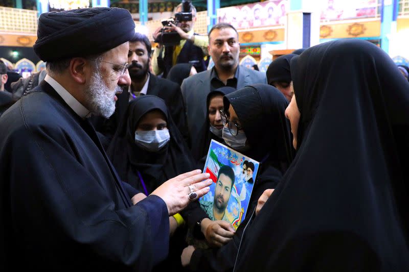 Iranian President Ebrahim Raisi meets with the families of security forces killed during Iran's protests, in Tehran