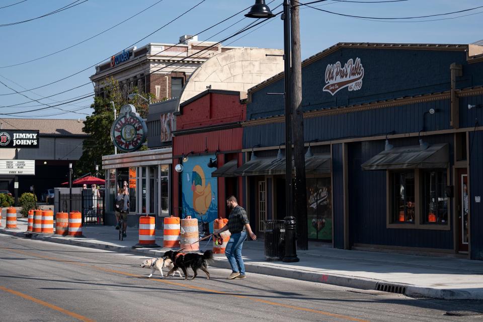 A pedestrian walk along the 800 block of Broad Ripple Avenue on Tuesday, Sept. 19, 2023, in Indianapolis. After three people were killed in the area late one Saturday night in June, an idea was hatched to make the entertainment district a gun-free zone on Friday and Saturday nights. Now it seems the plan, a dual effort of the Broad Ripple Village Association and city officials, may never come to fruition, due to logistical hurdles.