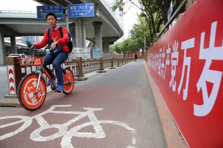 A man cycles past a banner reading "Long live the great Communist Party of China" in Beijing, as the capital prepares for the 19th National Congress of the Communist Party of China, October 14, 2017. REUTERS/Jason Lee