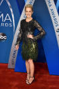 <p>The singer kept things flirty with a lace and sequin black dress. She made the piece even flashier with green feathers on the hemline. (Photo: Getty Images) </p>