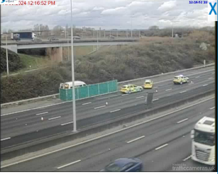 Emergency vehicles still at the scene of the crash, around 12.15pm (Highways England)