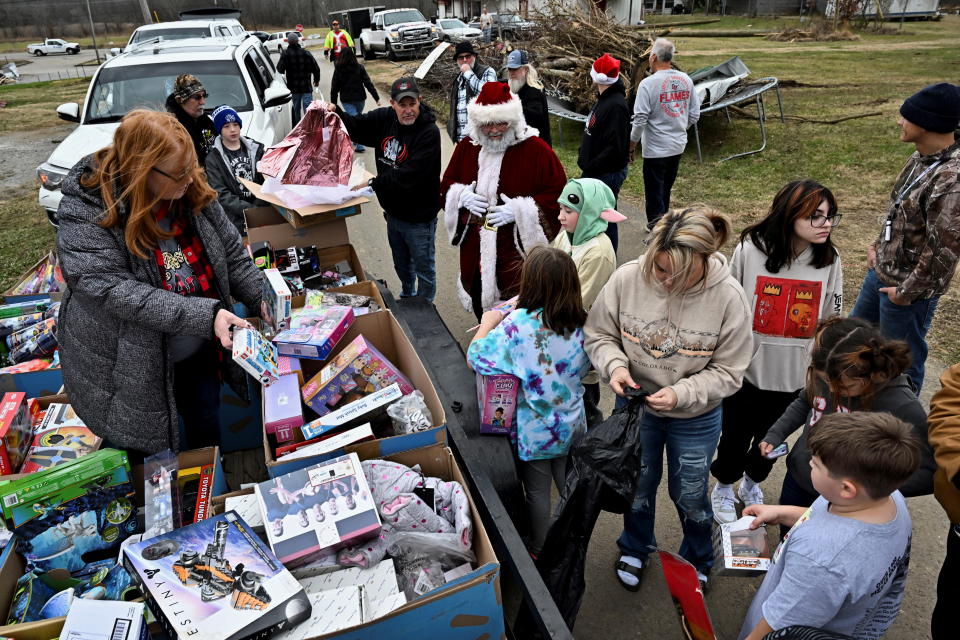 Volunteers associated with various church groups celebrate Christmas Eve by passing out toys to children in heavily damaged neighborhoods after tornadoes ripped through several U.S. states in Dawson Springs, Kentucky, U.S., December 24, 2021. REUTERS/Jon Cherry