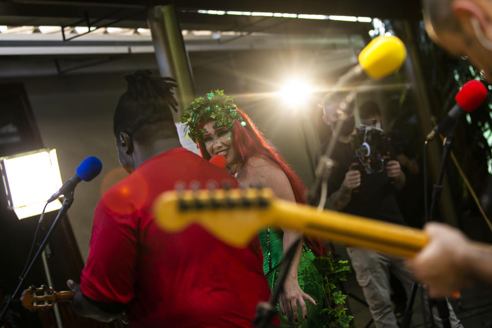 Musicians perform in the "Desliga da Justica" street band in Rio de Janeiro, Brazil, Sunday, Feb. 14, 2021. Their performance was broadcast live on social media for those who were unable to participate in the carnival due to COVID restrictions after the city's government officially suspended Carnival and banned street parades or clandestine parties. (AP Photo/Bruna Prado)