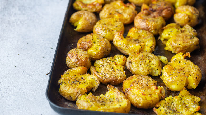 Smashed baby potatoes on pan