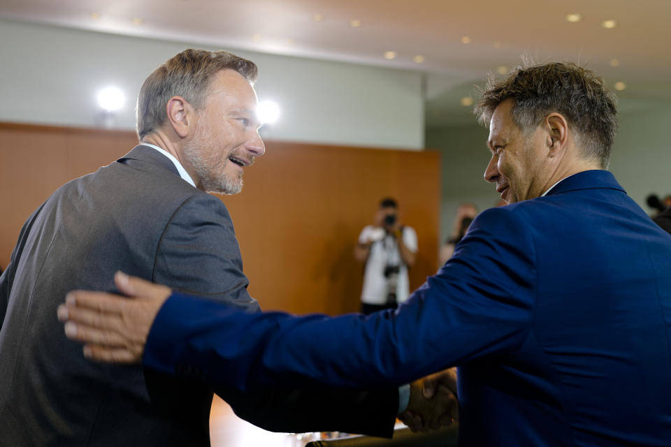 German Vice Chancellor and Minister for Economy and Climate Robert Habeck, right, greets Finance Minister Christian Lindner prior to the cabinet meeting of the German government at the chancellery in Berlin, Germany, Wednesday, July 27, 2022. (AP Photo/Markus Schreiber)
