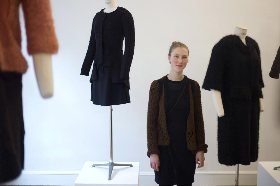 French fashion designer Alice Lemoine poses among her creations as part of the presentation of Le Moine Tricote's ready-to-wear Fall/Winter 2013-2014 collection, presented in Paris, Tuesday, Feb. 26, 2013. (AP Photo/Thibault Camus)