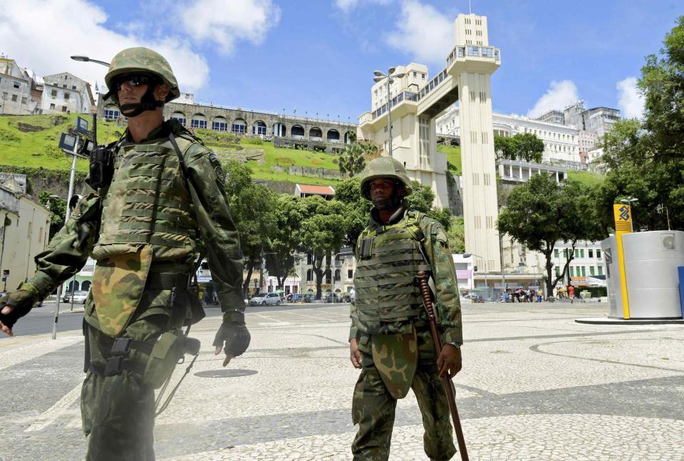 Soldiers patrol the city center during a police strike in Salvador, Bahia state, April 17, 2014. A police strike has unleashed violent crime in Brazil's third-largest city just two months before it is set to welcome hordes of soccer fans for the World Cup, adding to fears about the country's ability to ensure safety during the event. At least 22 people were killed in and around the northeastern city of Salvador after state police went on strike early on Wednesday to demand better pay and other benefits, the Bahia state government said on Thursday, prompting the federal government to dispatch troops to restore order. REUTERS/Valter Pontes (BRAZIL - Tags: CRIME LAW POLITICS CIVIL UNREST SPORT SOCCER WORLD CUP)