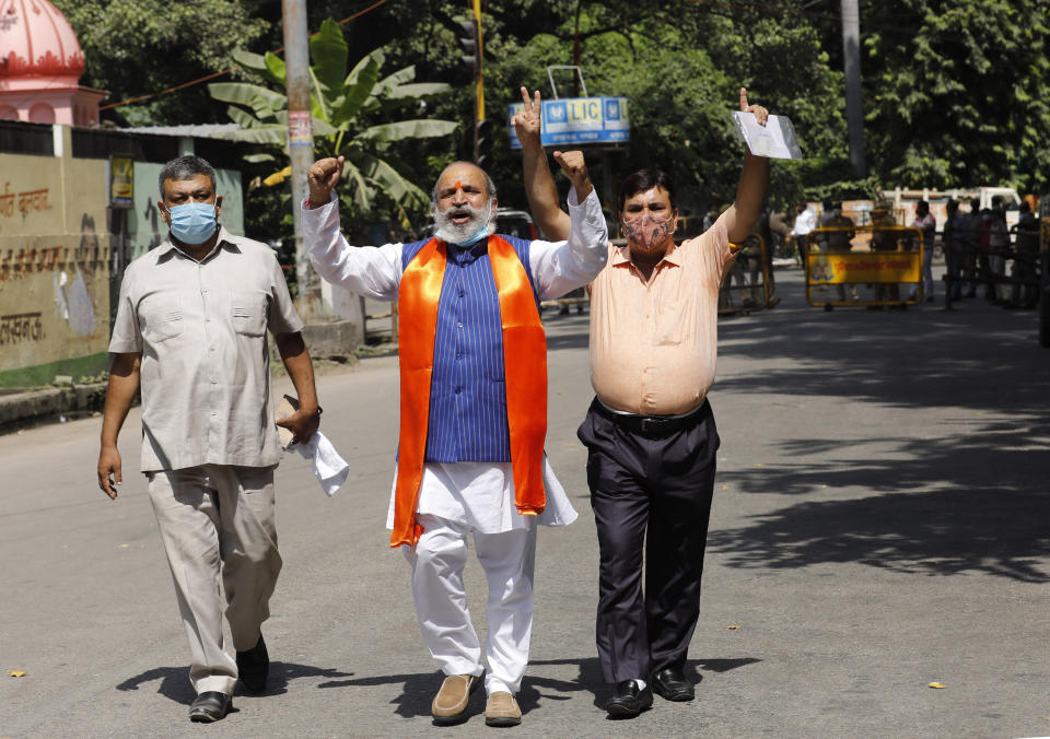 Jai Bhagwan Goyal, center, a leader of India's ruling Bharatiya Janata Party and an accused in the 1992 attack and demolition of a 16th century mosque, celebrates outside a court in Lucknow, India, Wednesday, Sept. 30, 2020. An Indian court on Wednesday acquitted all 32 accused, including senior leaders of the ruling Hindu nationalist Bharatiya Janata Party, in the case. The demolition sparked Hindu-Muslim violence that left some 2,000 people dead. (AP Photo/Rajesh Kumar Singh)