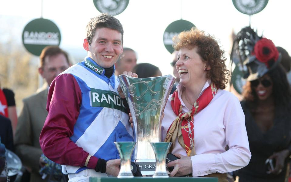 Jockey Derek Fox and trainer Lucinda Russell celebrate with the trophy - Credit: PA