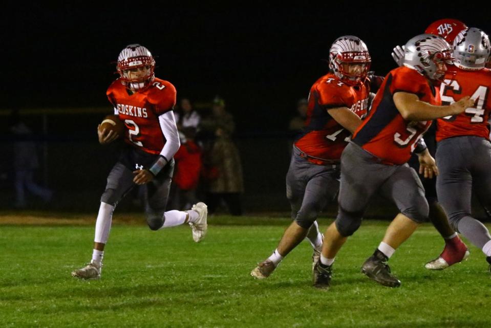 Utica senior quarterback Zach Heckman gets to the outside as sophomores Kaden Baker (56) and Grayson Tyo (77) pull and seal during last week's game against Johnstown.