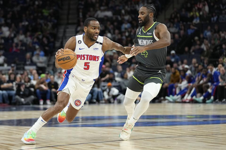 Pistons guard Alec Burks works towards the basket against Timberwolves guard Jaylen Nowell during the first half on Saturday, Dec. 31, 2022, in Minneapolis.