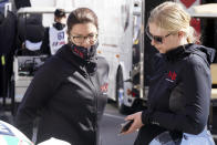 Drivers Katherine Legge, left, of Great Britain, and Christina Nielsen, of Denmark, talk outside their garage after a practice session for the Rolex 24 hour race at Daytona International Speedway, Friday, Jan. 29, 2021, in Daytona Beach, Fla. The two women will team up with drivers and team co-owners Rob Ferriol and Earl Bamber in the No. 88 Team Hardpoint EBM Porsche 911 GT3 R.(AP Photo/John Raoux)