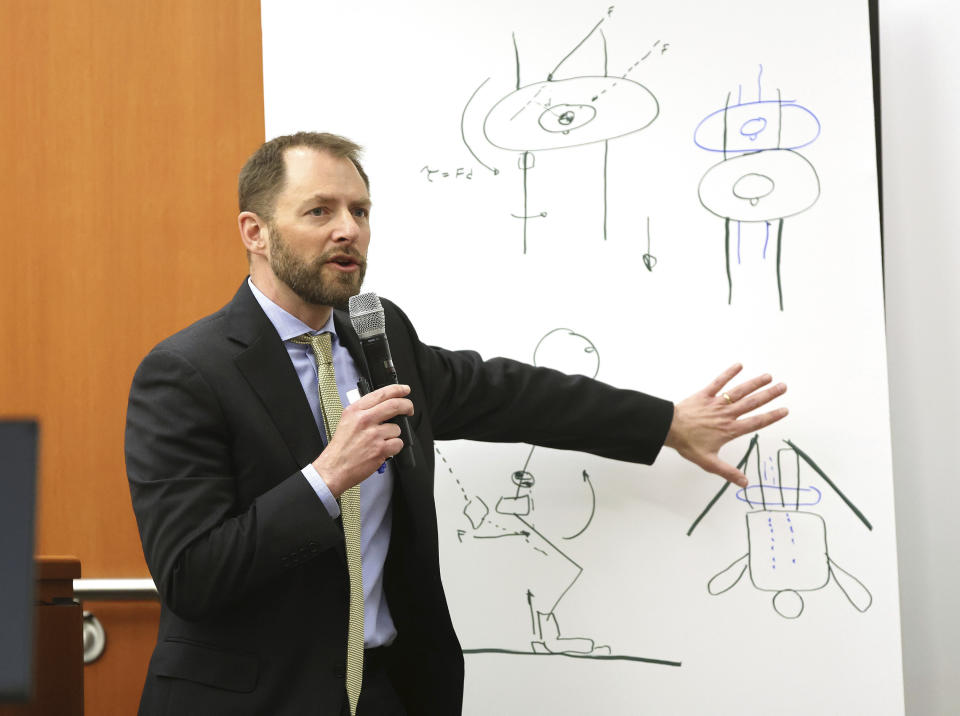 Dr. Irving Scher shows an accident simulation during testimony in Gwyneth Paltrow's trial, Tuesday, March 28, 2023, in Park City, Utah. Paltrow is accused in a lawsuit of crashing into a skier during a 2016 family ski vacation, leaving him with brain damage and four broken ribs. (Jeffrey D. Allred/The Deseret News via AP, Pool)