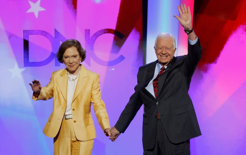 FILE PHOTO: Former U.S. President Carter and former first lady Rosalynn arrive onstage in Denver