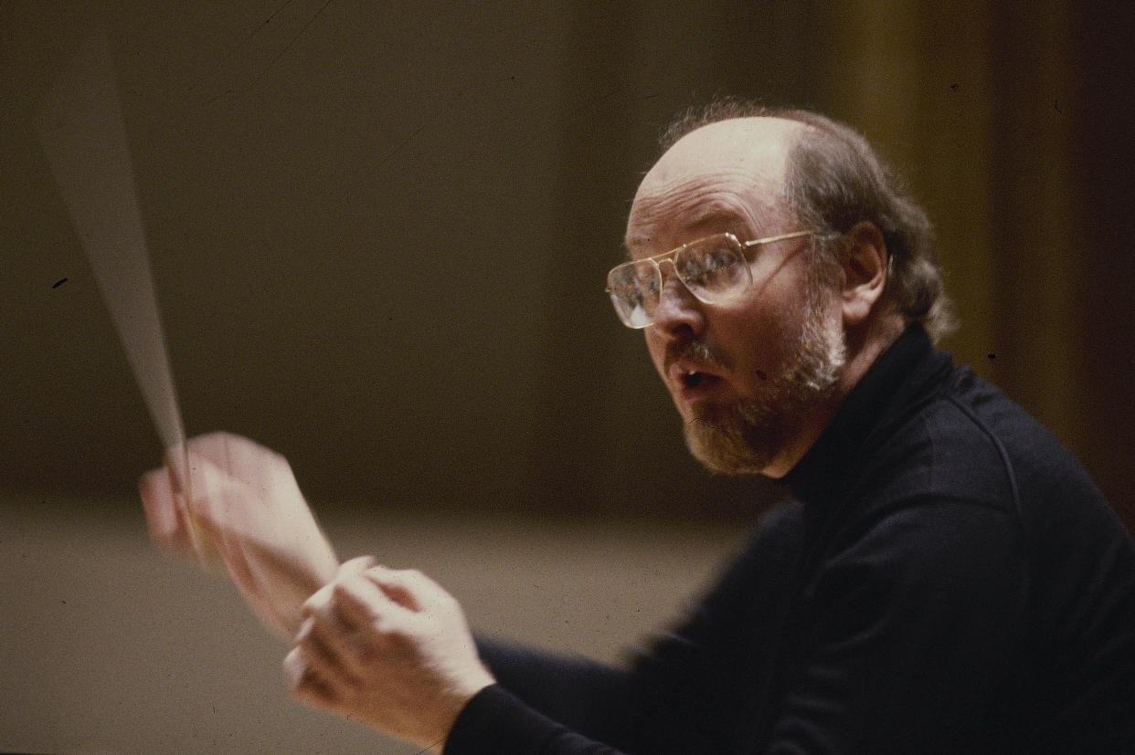 FILE - Boston Pops Conductor John Williams conducting the orchestra in Boston in 1980. Williams, 90, is devoting himself to composing concert music, including a piano concerto he’s writing for Emanuel X. This spring, he and cellist Yo-Yo Ma released the album “A Gathering of Friends,” recorded with the New York Philharmonic. (AP Photo, File)