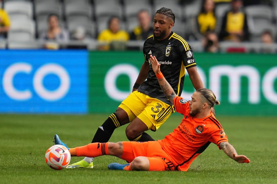 Mar 12, 2024; Columbus, OH, USA; Houston Dynamo midfielder Sebastian Kowalczyk (27) kicks the ball away from Columbus Crew defender Steven Moreira (31) during the first half of the Concacaf Champions Cup soccer game at Lower.com Field. Mandatory Credit: Adam Cairns-USA TODAY Sports