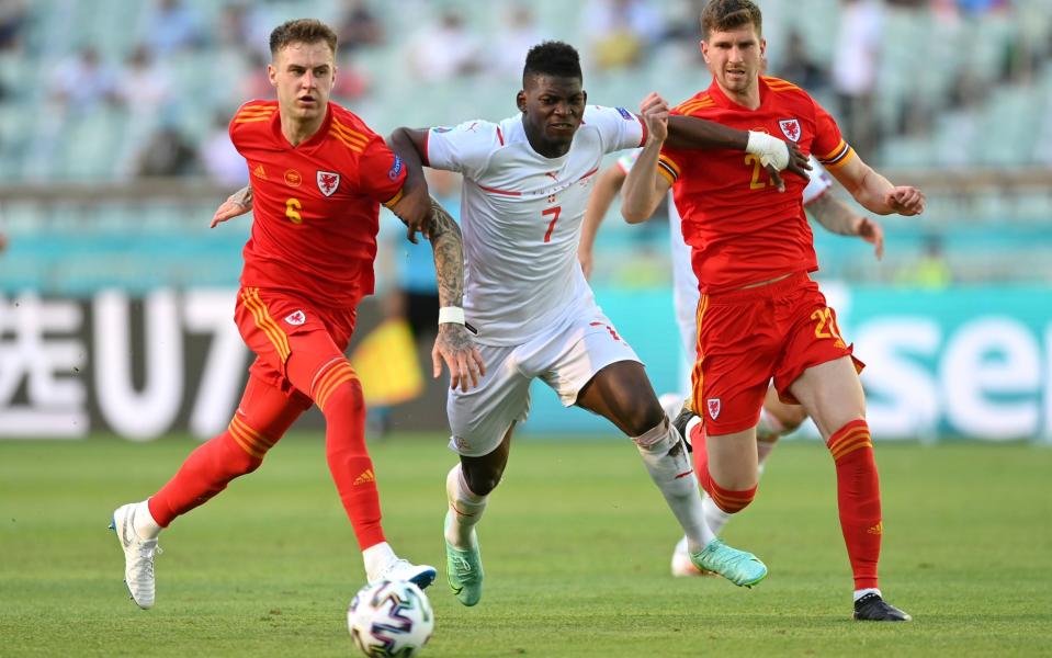 Breel Embolo bursts past Joe Rodon and Chris Mepham during Wales' 1-1 draw with Switzerland - GETTY IMAGES