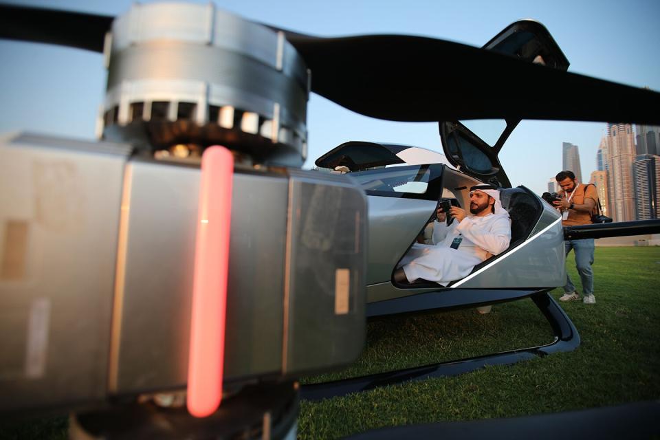 People inspect the eVTOL flying car X2 during the world-first public flight as part of the Gulf Information Technology Exhibition (GITEX) Global 2022 at the runway of SkyDive Dubai in the Gulf emirate of Dubai, United Arab Emirates, 10 October 2022.