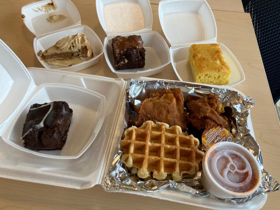 Here is a spread of dessert and the chicken and waffles from Showcase Meats in Akron's Kenmore neighborhood. Pictured clockwise from bottom left: Mississippi mud cake, maple sweet potato cheesecake, caramel mocha brownie, cornbread and chicken and waffles with a side of hot rice.