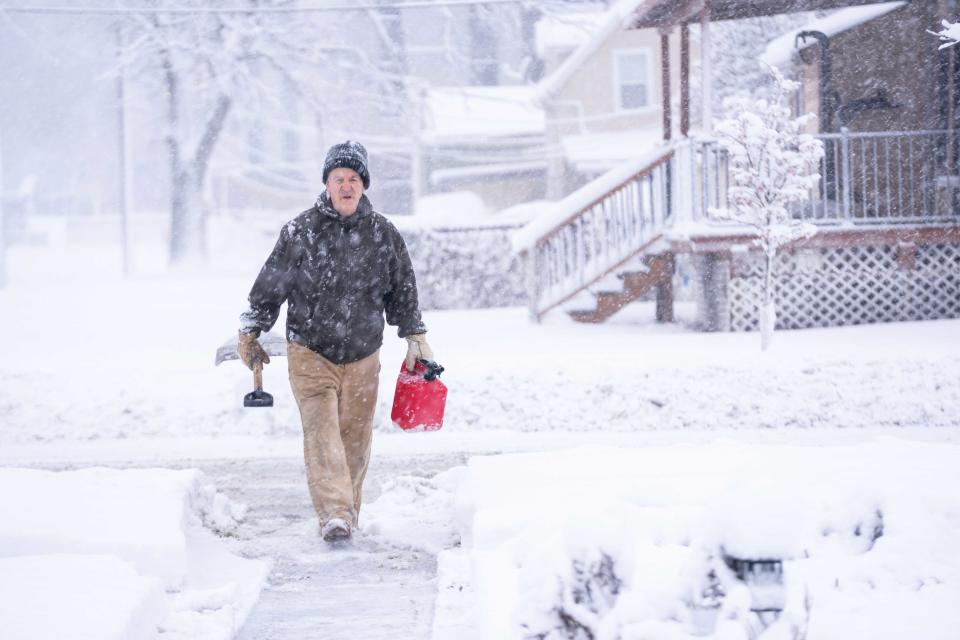 Residents work to clear snow from their sidewalks and driveways after an overnight snow storm Tuesday, Jan. 9, 2024, in Des Moines, Iowa.