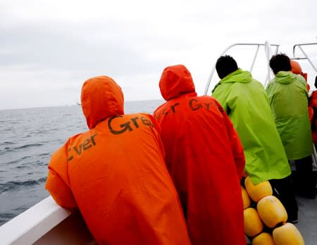 Tourists on a whale watching tour boat look for whales in the sea near Rausu