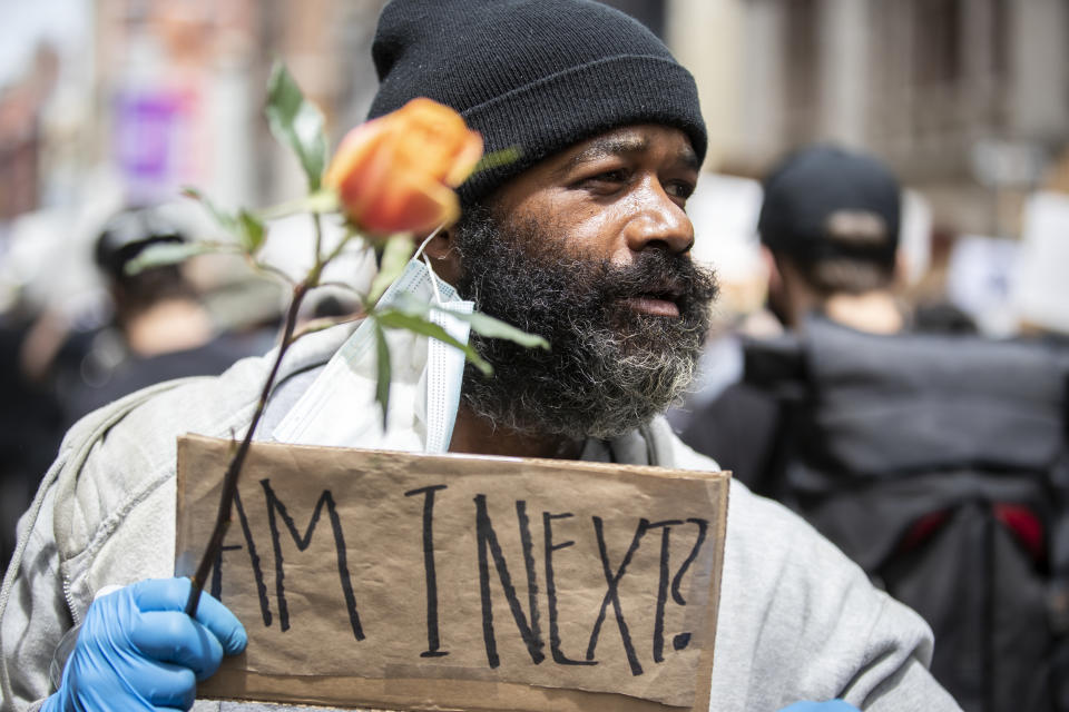 A man on cheering on the protesters as they make their way down Broadway Street holds a flower and a sign that says, "Am I Next"? Photographed in the Manhattan Borough of New York on June 02, 2020, USA. (Photo by Ira L. Black/Corbis via Getty Images)